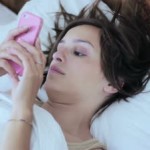 stock-footage-young-beautiful-woman-using-on-bed-and-holding-smartphone stock-footage-young-beautiful-woman-using-on-bed-and-holding-smartphone